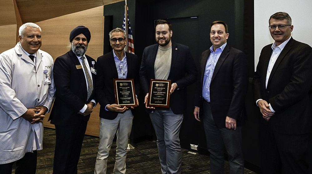 Group photo of University and Stritch leaders with the two award winners